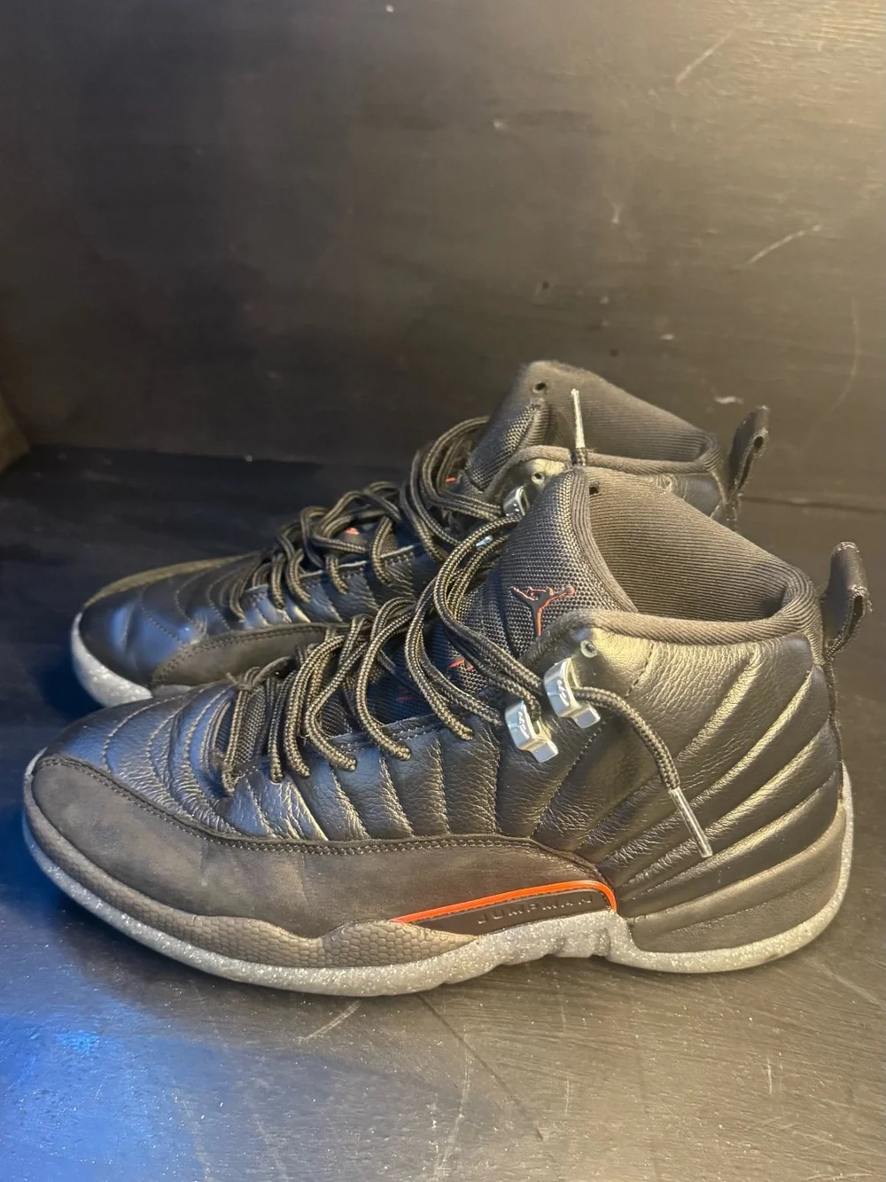 Men's Jordan 12 Black High-Top Athletic Sneakers with Subtle Orange Accent